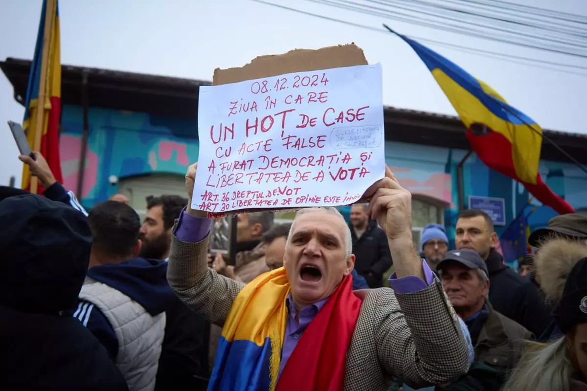 A supporter of the far-right ultranationalist runoff candidate for the presidency of Romania, Calin Georgescu, shouts as Georgescu (not in picture) speaks to the press at a closed polling station for the second round of the presidential electionelection that was supposed to take place today. Due to irregularities in Georgescu's campaign, the Constitutional Court of Romania (CCR) decided to annul the entire presidential electoral process, invoking Article 146(f) of the Constitution. The electoral process for electing the President of Romania will be restarted from scratch, with the government tasked with setting a new date. Calin Georgescu, presidential elections in Romania legally cancelled, Bucharest, Ilfov, Romania - 08 Dec 2024