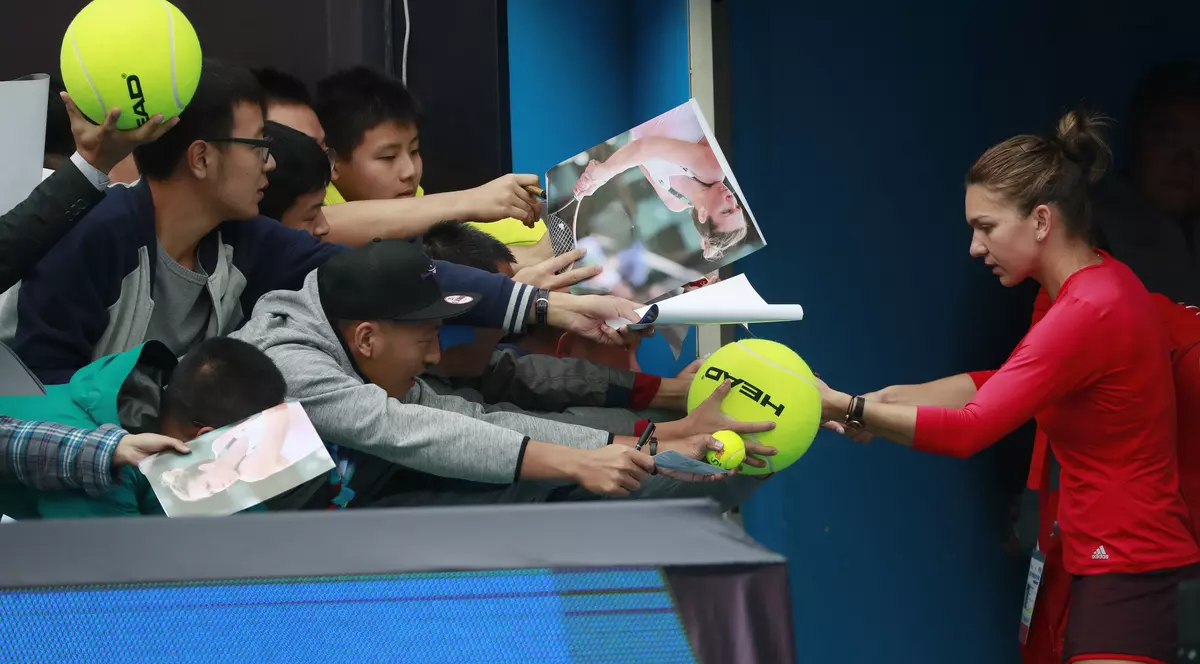 Simona Halep, dând autografe unor fani la finalul unui meci. (FOTO: EPA)