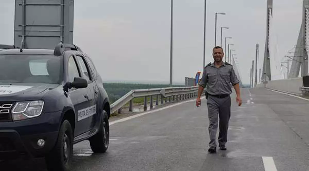 Circulaţia pe podul Calafat-Vidin va fi întreruptă, pe 4 iulie. Un polițist de frontieră merge spre mașina de serviciu, pe podul Cașafat-Vidin,