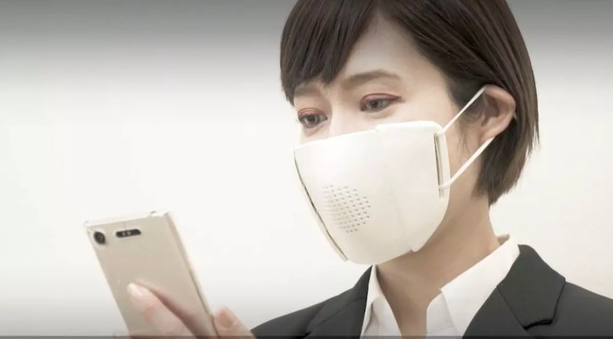 Japonezii au inventat “masca inteligentă”. Aceasta este conectată la smartphone și poate da mesaje sau apeluri telefonice. Japonez[ ]n costum care are masca inteligentă pe față și vorbește la smartphone
