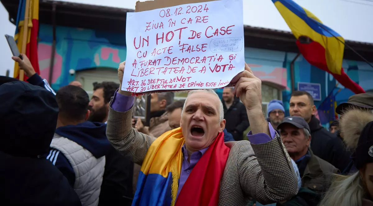 A supporter of the far-right ultranationalist runoff candidate for the presidency of Romania, Calin Georgescu, shouts as Georgescu (not in picture) speaks to the press at a closed polling station for the second round of the presidential electionelection that was supposed to take place today. Due to irregularities in Georgescu's campaign, the Constitutional Court of Romania (CCR) decided to annul the entire presidential electoral process, invoking Article 146(f) of the Constitution. The electoral process for electing the President of Romania will be restarted from scratch, with the government tasked with setting a new date. Calin Georgescu, presidential elections in Romania legally cancelled, Bucharest, Ilfov, Romania - 08 Dec 2024