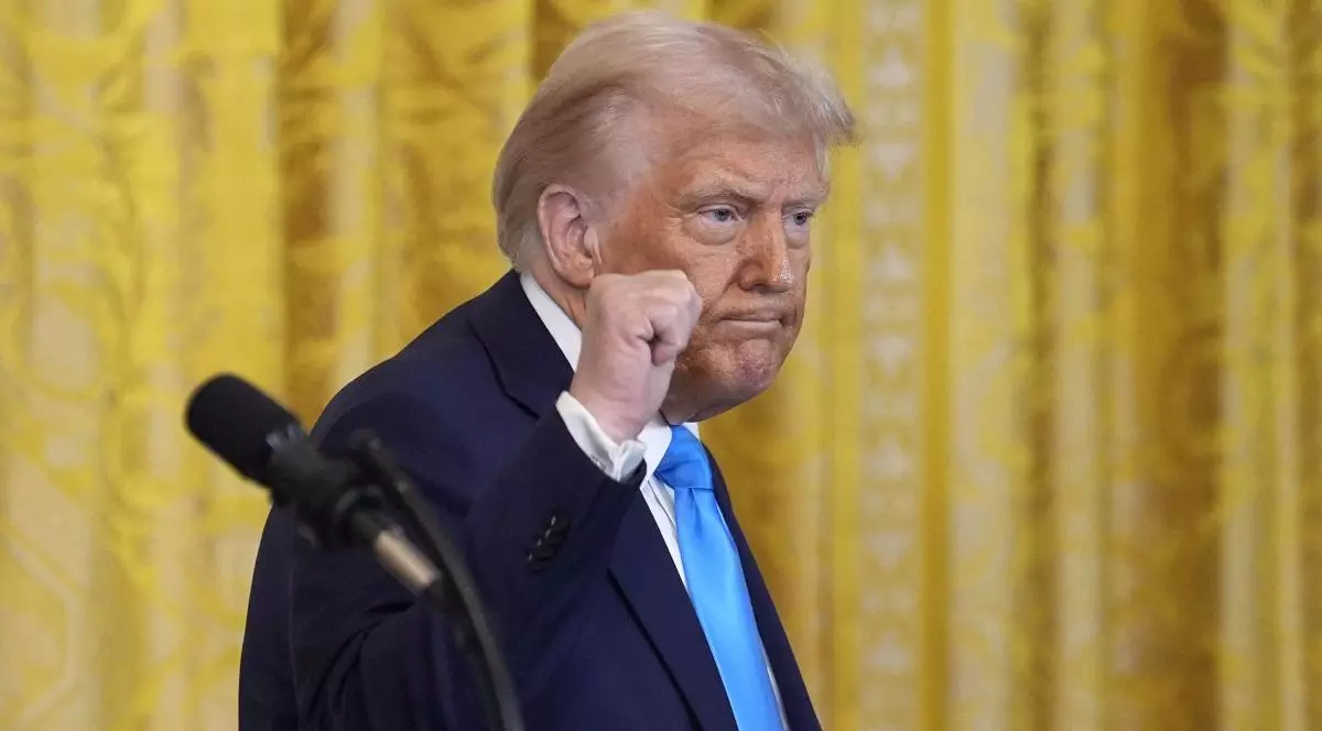 Președintele Donald Trump face gesturi în timpul unei conferințe de presă comună cu premierul Benjamin Netanyahu după întâlnirea lor de la Casa Albă din Washington, pe 4 februarie 2025. Republicanul este cu pumnul ridicat. Trump este îmbrăcat la costum, are o cămașă albă și o cravată albastră