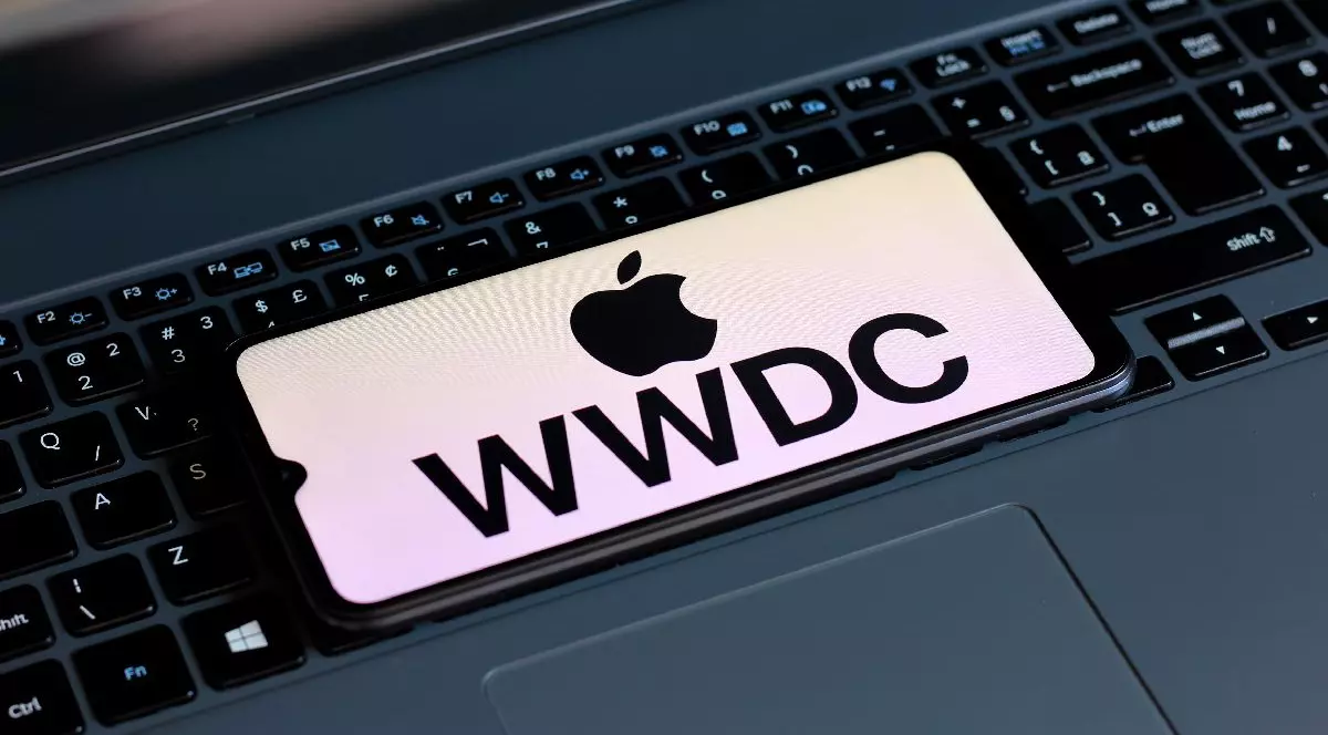 Logoul Apple WWDC, pe un ecran al unui smartphone așezat pe o tastatură de laptop.