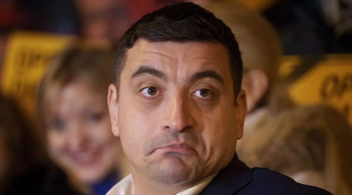 George Simion surprins în cadrul unei conferințe de presă în timp ce se strâmba