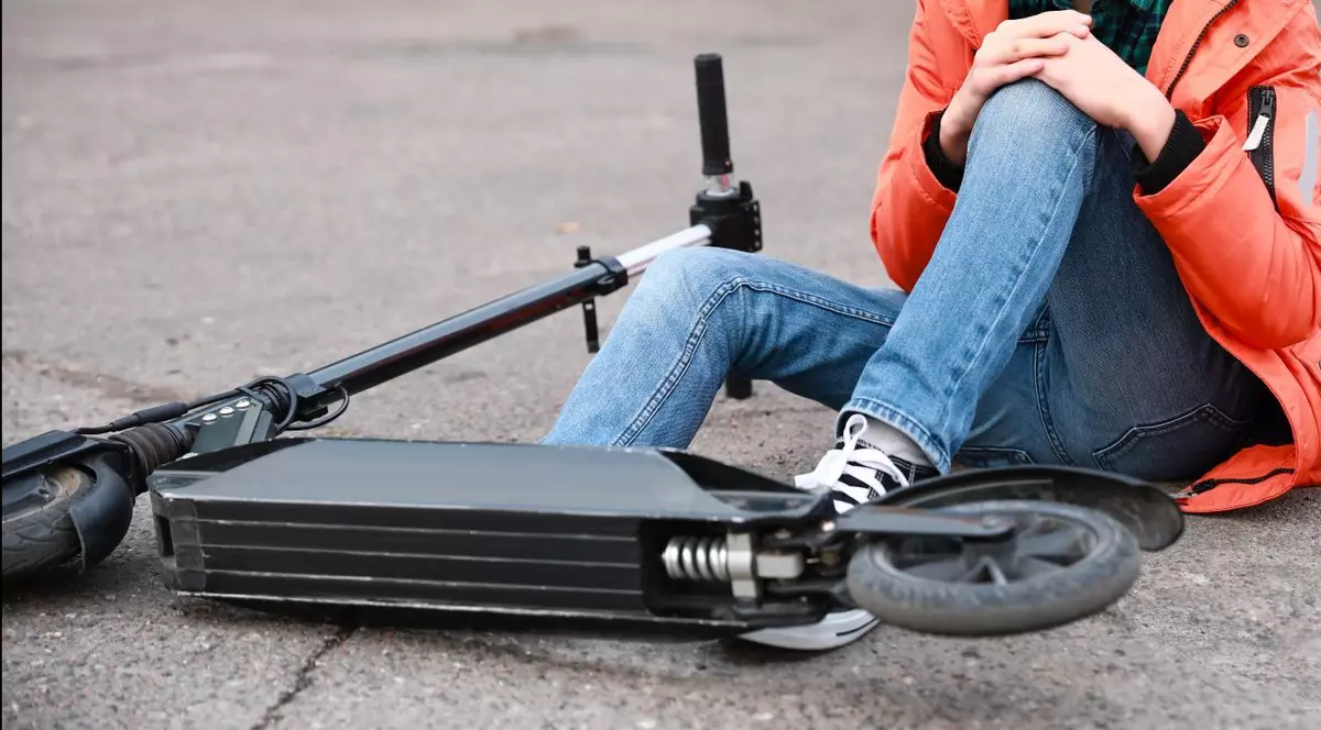 Trotinetă căzută pe asfalt