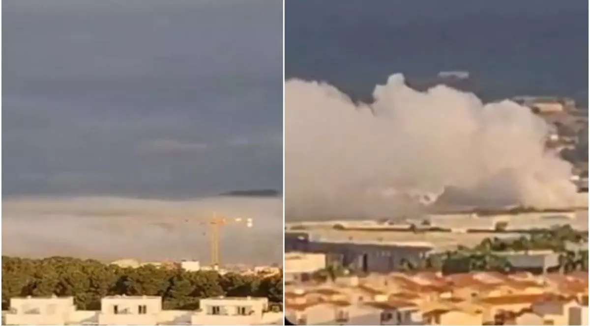 Nori de clor se văd pe cerul Cataloniei, deasupra blocurilor, iar o macara este acoperită ne nor și se vede ca prin ceață