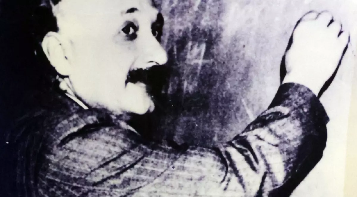 Imagine alb-negru cu Albert Einstein, in timp ce scrie pe o tablă