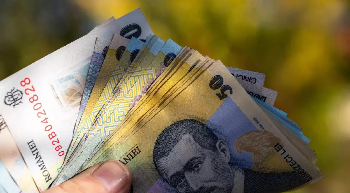 bancnote de 50, 100 și 200 de lei ținute sub formă de evantai în mâna de un bărbat