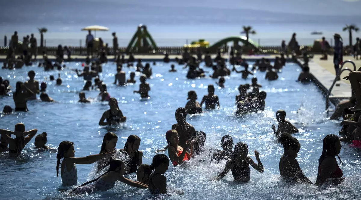 Imagine cu mai mulți oameni într-o piscină din Elveția
