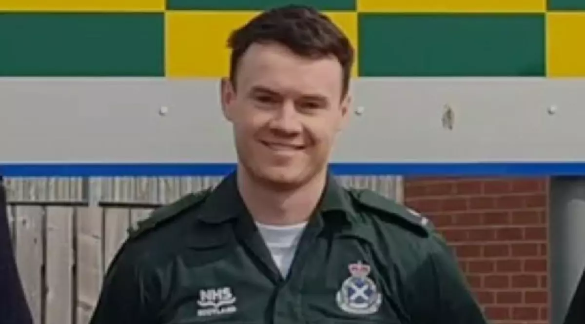 Un bărbat în uniformă NHS de culoare verde închis