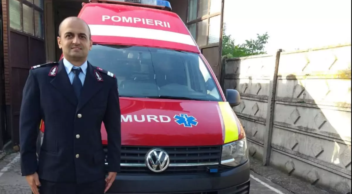 Plutonierul Brîndaș Sergiu lângă o mașină de pompieri SMURD
