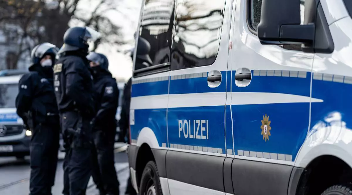 Mai multi politisti in Germania, langa o masina de politie, iarna