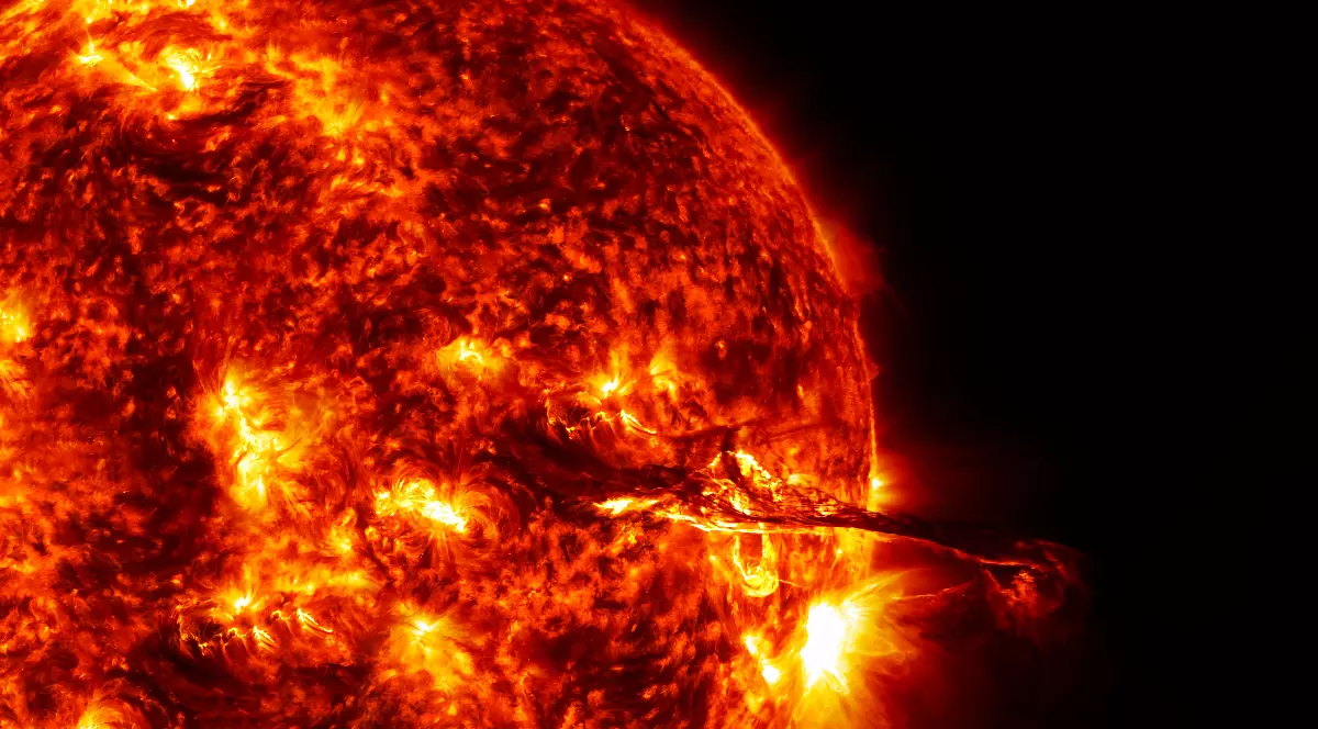 În imagine se vede Soarele surprins de aproape, cu suprafața sa incandescentă și multiple erupții solare active, din care se desprind arcuri de plasmă fierbinte. Zonele luminoase indică explozii intense de energie, sugerând o activitate solară extrem de puternică.