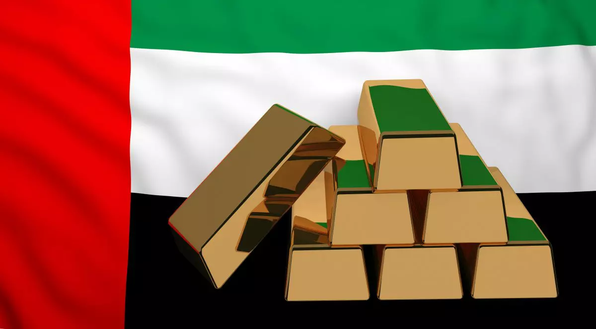 Șase lingouri de aur au pe fundal steagul Emiratelor Arabe Unite