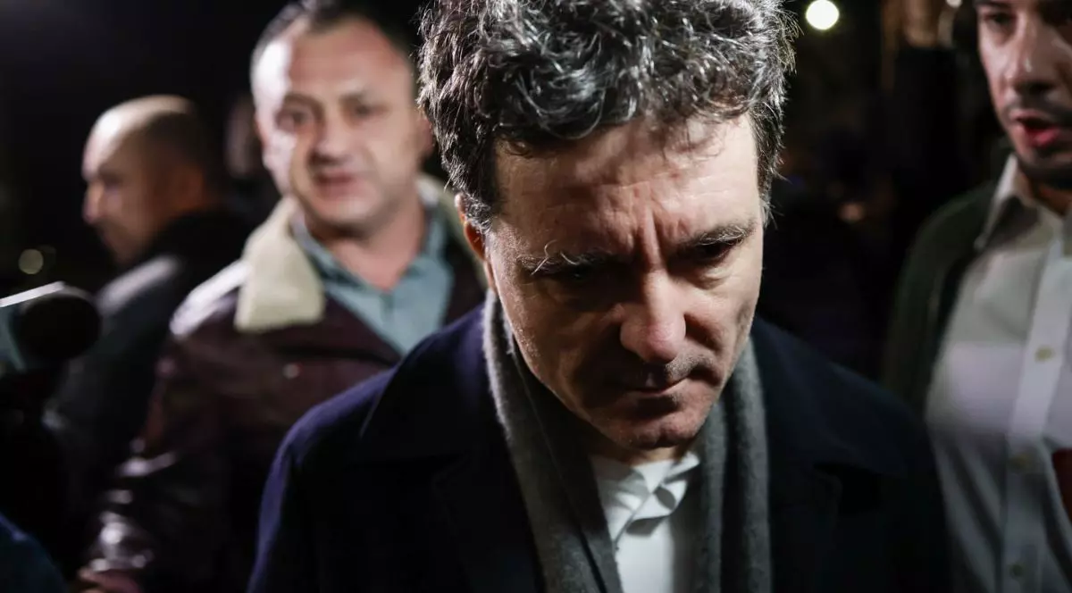 Nicușor Dan, îmbrăcat într-un palton negru cu un fular gri în jurul gâtului, înconjurat de jurnaliști, în întuneric, în fața Palatului Cotroceni, 6 martie 2026