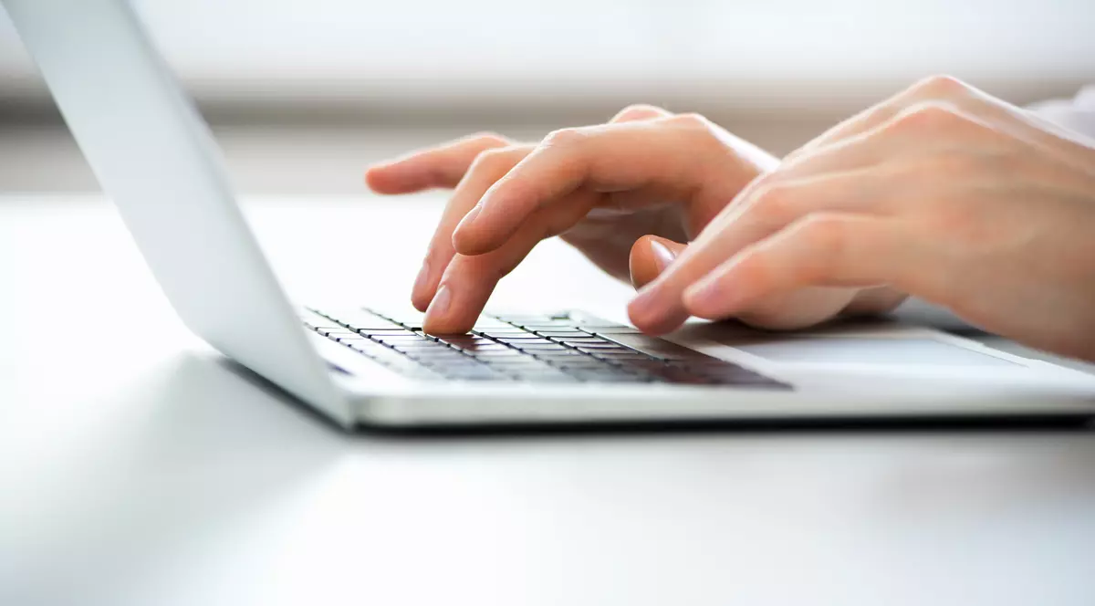 Close-up of hands of business man typing on a laptop.