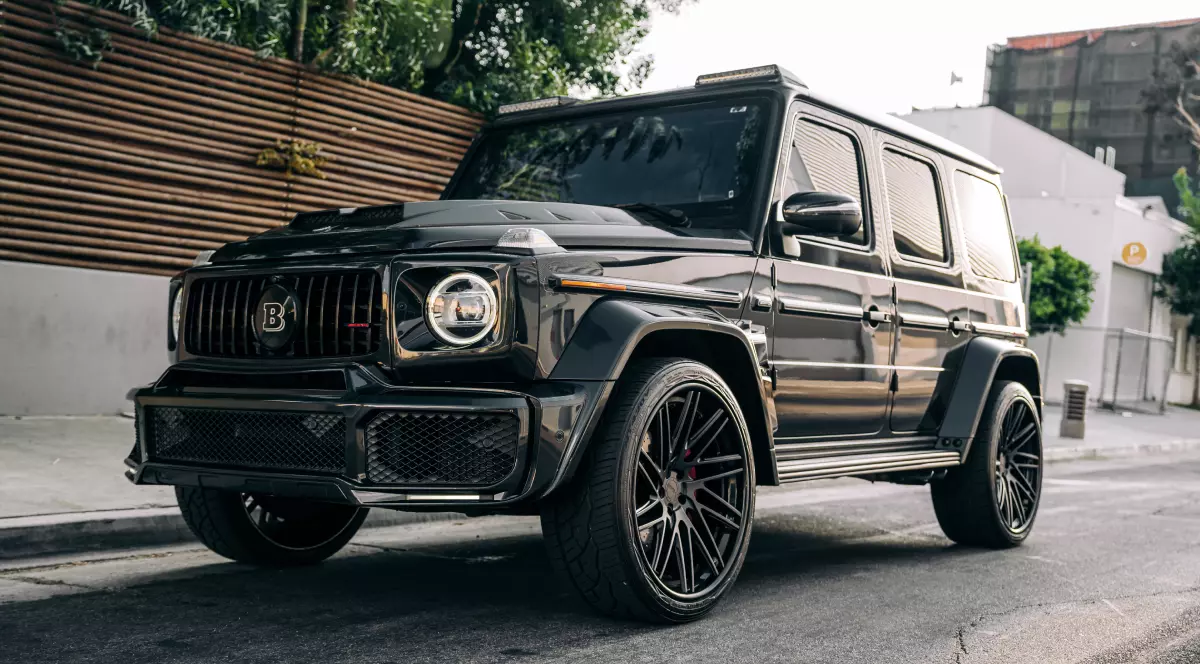 Mercedes G-Class negru, parcat lângă un gard.