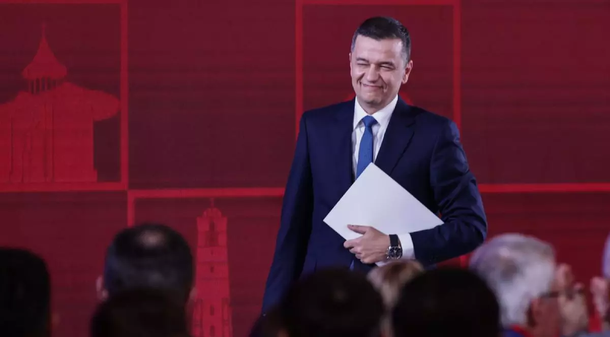 Sorin Grindeanu în costum negru, cămașă albă, în timp ce zâmbește