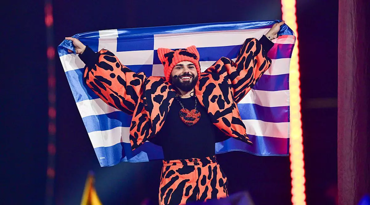VIENNA, AUSTRIA - MAY 16: Akylas representing Greece walks into the grand final carrying the Greek flag during the Grand Final of the 70th Eurovision Song Contest at Wiener Stadthalle on May 16, 2026 in Vienna, Austria. (Photo by Christian Bruna/Getty Images)