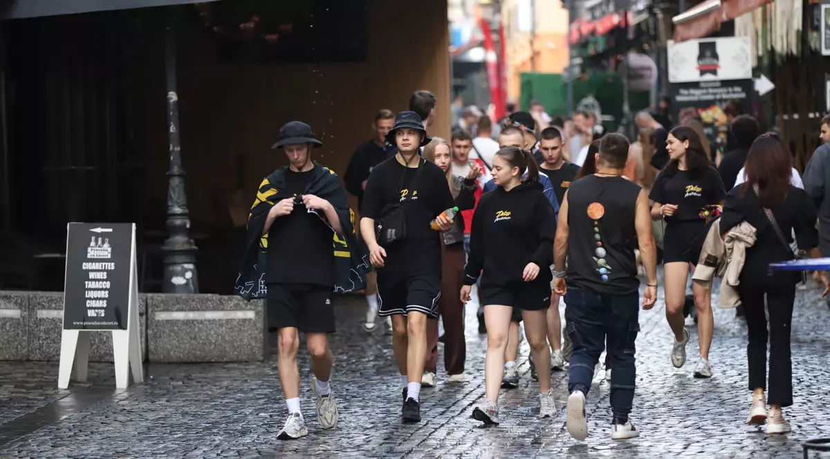 un grup de persoane, imbracati in negru, se plimba prin centrul istoric al Bucurestiului