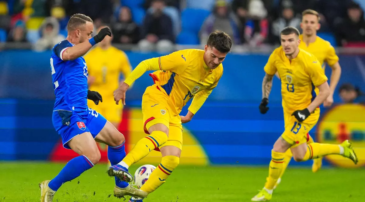 BRATISLAVA, SLOVAKIA - MARCH 31: Peter Pekarik of Slovakia and Ianis Hagi of Romania battle for possession during the International Friendly match between Slovakia and Romania at Narodny futbalovy stadion on March 31, 2026 in Bratislava, Slovakia. (Photo by Christian Hofer/Getty Images)