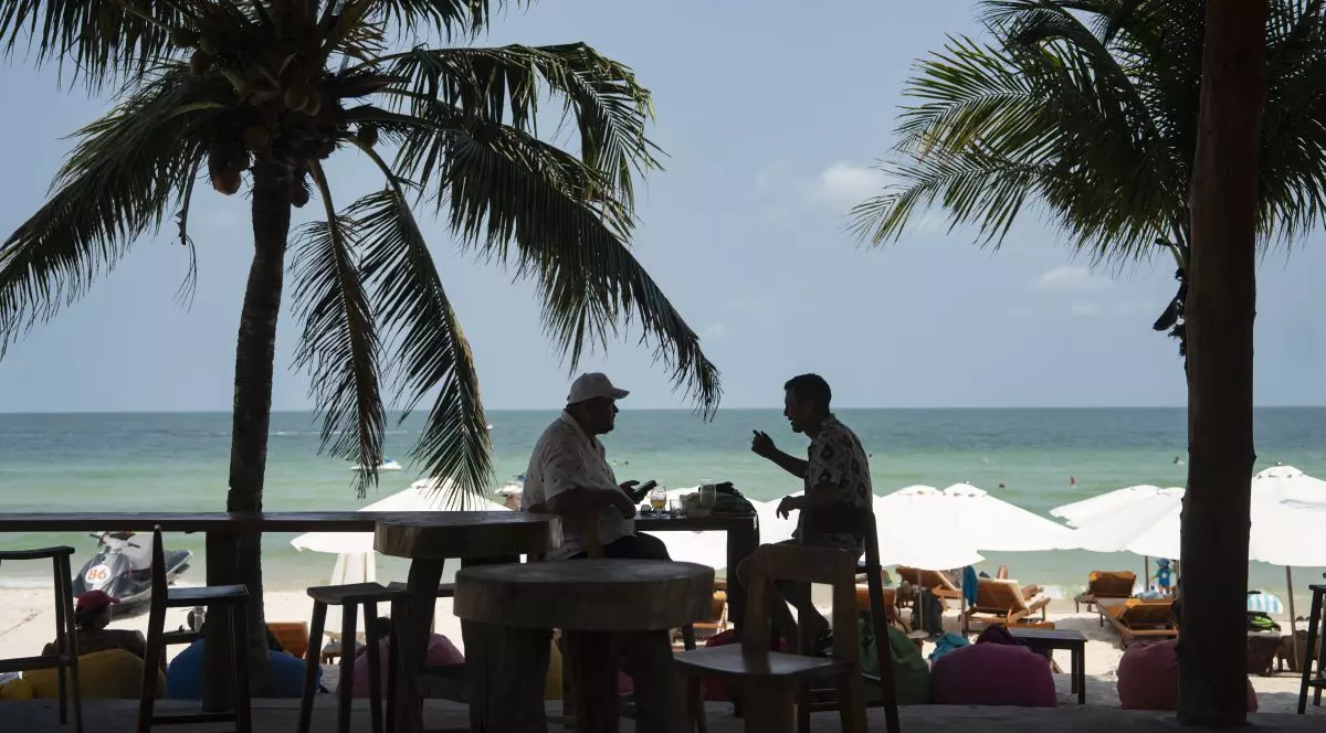 PHU QUOC, VIETNAM - MARCH 20: Tourists sit at a restaurant at Sao Beach Bar on March 20, 2026 in Phu Quoc Vietnam. Vietnam recorded its strongest tourism year on record in 2025, welcoming 21.17 million international visitors (up over 20% year-over-year), which is the highest number of international visitors ever recorded in Vietnam. Vietnam's tourism authority has set a target of 25 million international visitors in 2026. (Photo by Allison Joyce/Getty Images)
