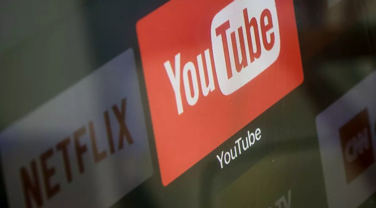 Logourile aplicațiilor YouTube și Netflix apar pe ecranul unui televizor, la 23 martie 2018, în Istanbul, Turcia.