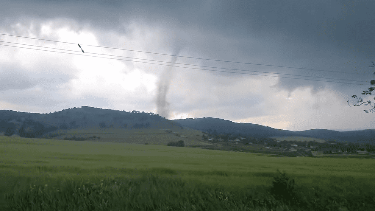 Un vârtej nnegru pe cer, într-o zonă cu dealuri