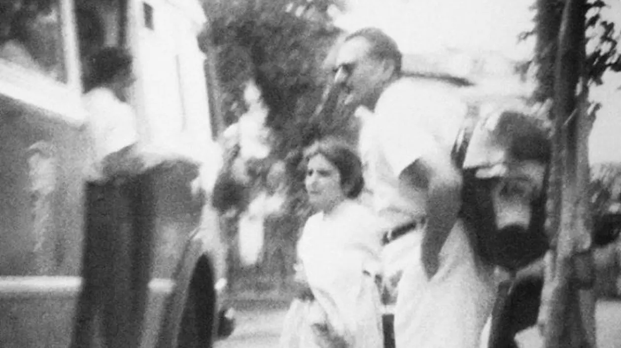 Fotografie inedită cu Arsenia Boca, din Arhiva CNAS. Arsenie Boca, alături de o femei, în 1962. Are ochelari de soare și poartă un rucsac în spate, fiind aici fără celebra sa barbă