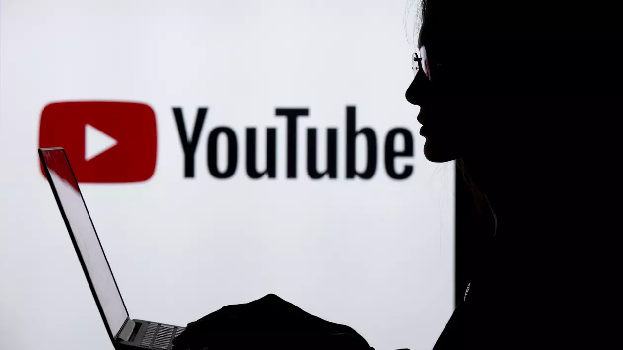 Serviciile YouTube Premium şi YouTube Music, disponibile de astăzi în România. Fată cu un laptop în față și sigla YouTube pe fundal