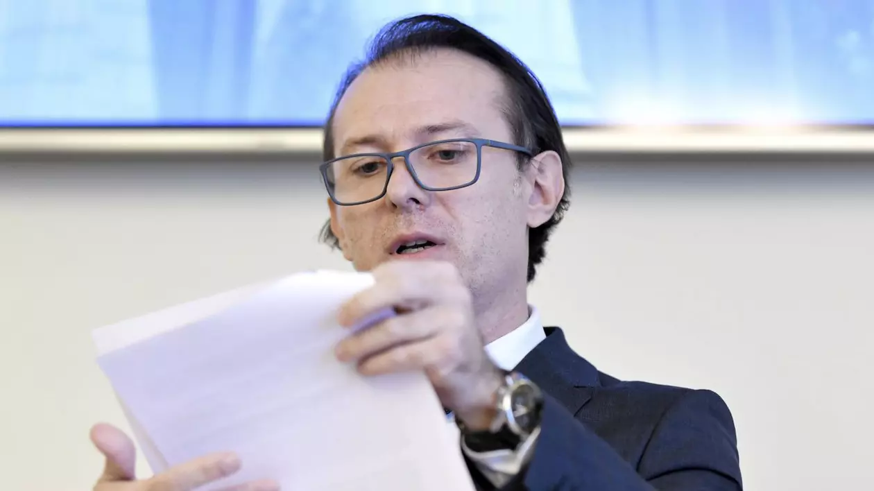 De unde taie Guvernul la rectificarea de buget: Apărare, Finanțe, Interne, Economie și STS și instituții autofinanțate. Florin Cîțu, ministrul Finanțelor, cu ochelari, citind de pe niște foi