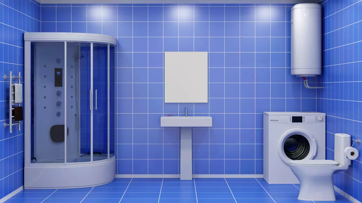Cum alegi cel mai bun boiler de apă caldă - Imagine cu o baie, cu gresie şi faianţă de culoare albastră, în care se pot observa un wc, un boiler, o chiuvetă, o maşină de spălat şi o cabină de duş