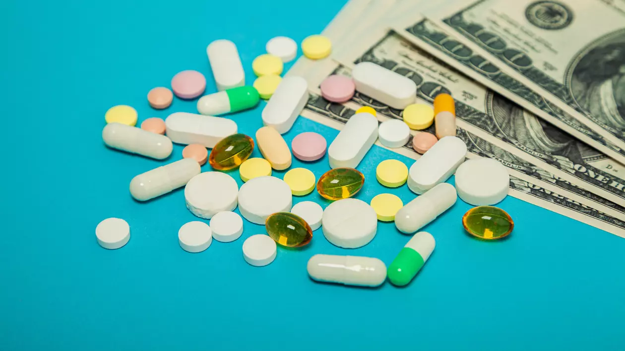 Care sunt cele mai scumpe medicamente din lume - Imagine cu mai multe pilule peste un teanc de bani