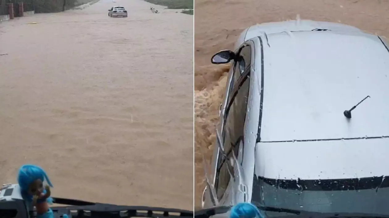 O mașină surprinsă de inundații este împinsă de un TIR condus de un șofer român, în timpul inundațiilor din Spania