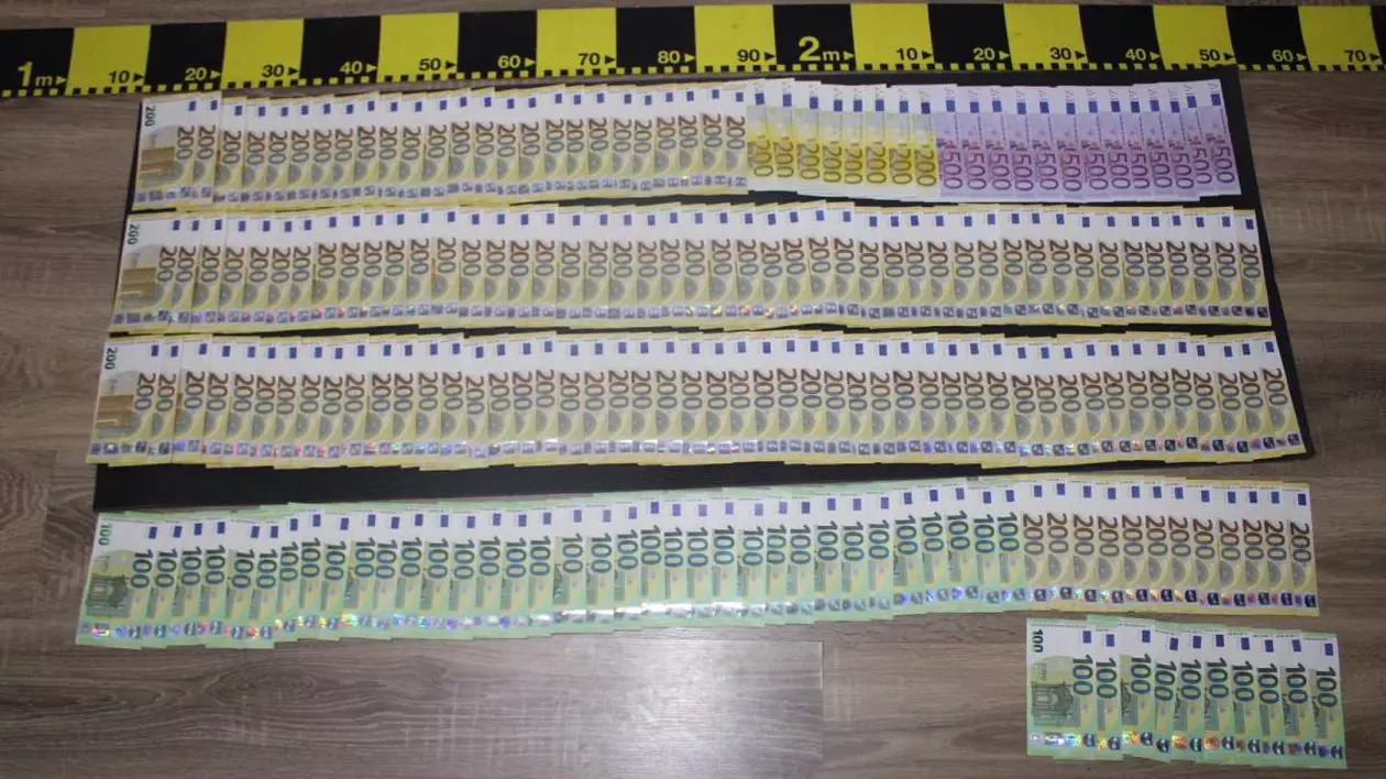 bancnote euro intinse pe o masa confiscate de politie