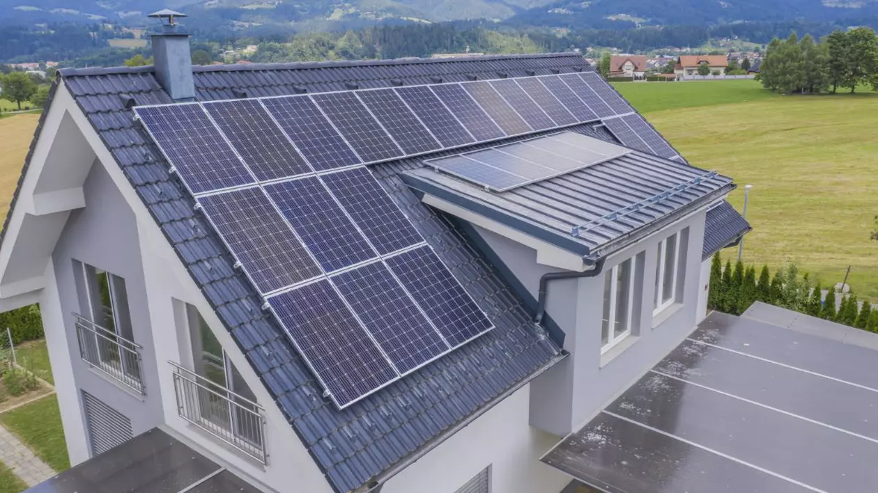casă cu panouri fotovoltaice montate pe acoperiș