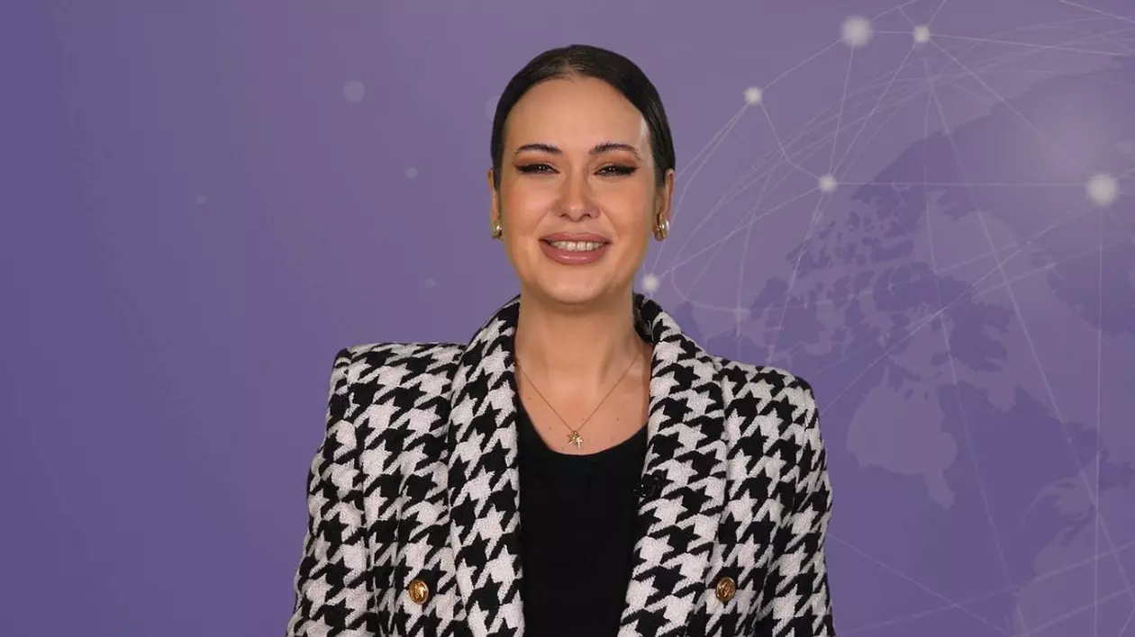 Denisa Macovei, gazda rubricii 5 știri by Libertatea - Monden, pe fundal mov, îmbrăcată cu un sacou în pătrățele albe și negre