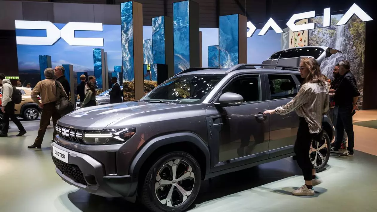 masina dacia duster la o expozitie auto. in jurul masinii sunt mai multe persoane care admira masina