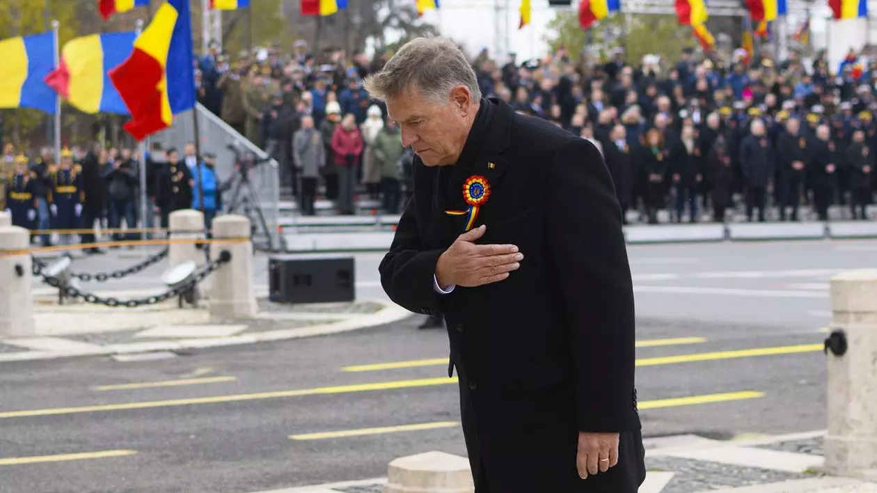 Președintele Klaus Iohannis, cu mâna dreaptă la piept, în fața unui grup de militari