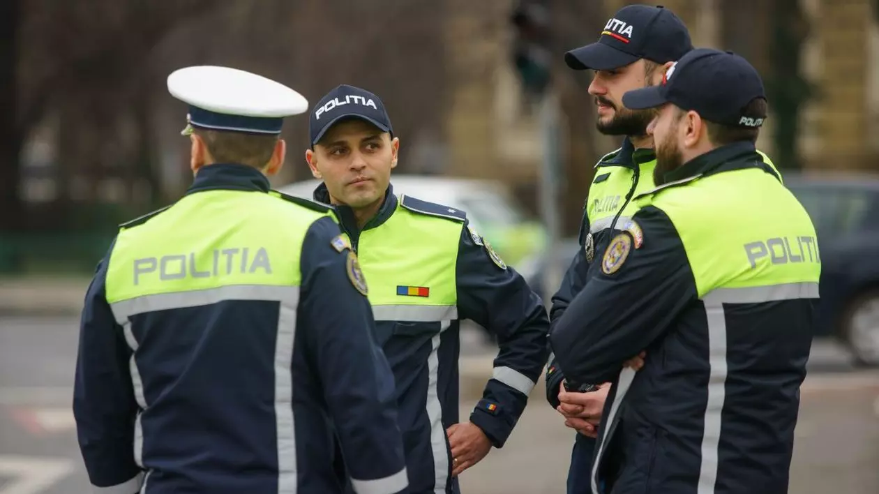 Patru polițiști de la Brigada Rutieră discută în plină stradă., Toți sunt în uniformă și au capetele acoperite