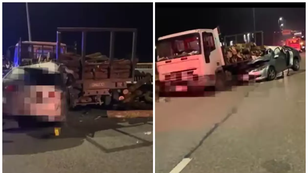 În imagine este ilustrată o mașină gri, care a intrat într-un camion încărcat cu lemne