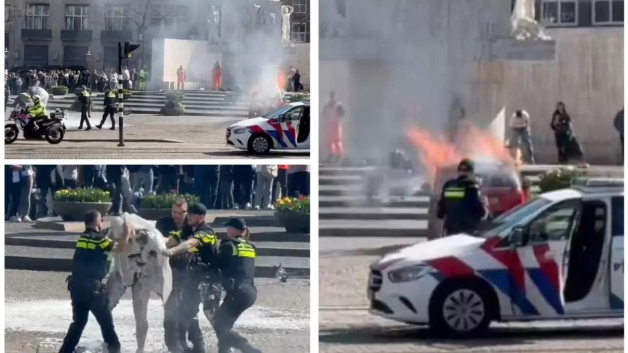 masina de politie si mai multi politisti pe o strada din Amsterdam, in timp ce o alta masina a luat foc