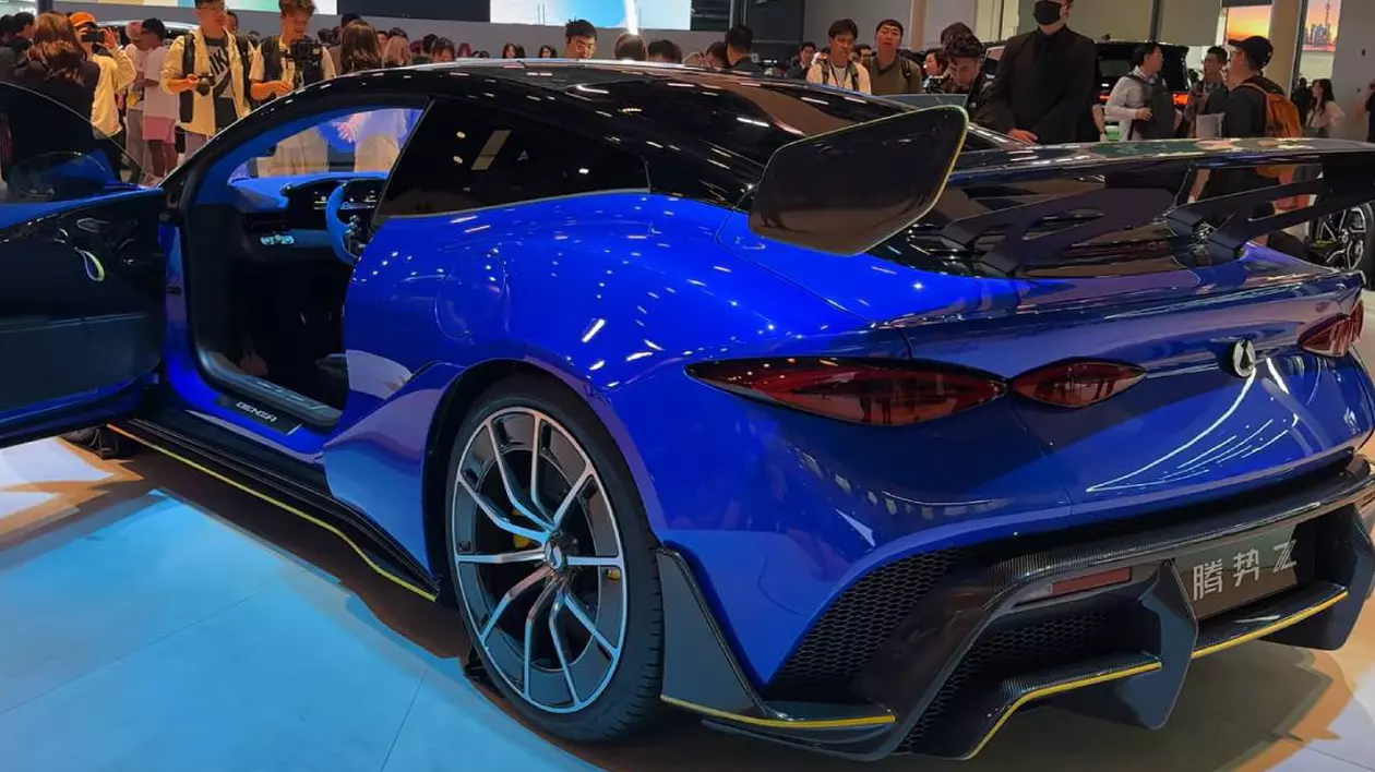 Denza Z9 GT, un vehicul sportiv electric de lux lansat de producătorul chinez BYD sub brandul Denza. Mașina este expusă într-un salon auto, fiind înconjurată de vizitatori și fotografi.