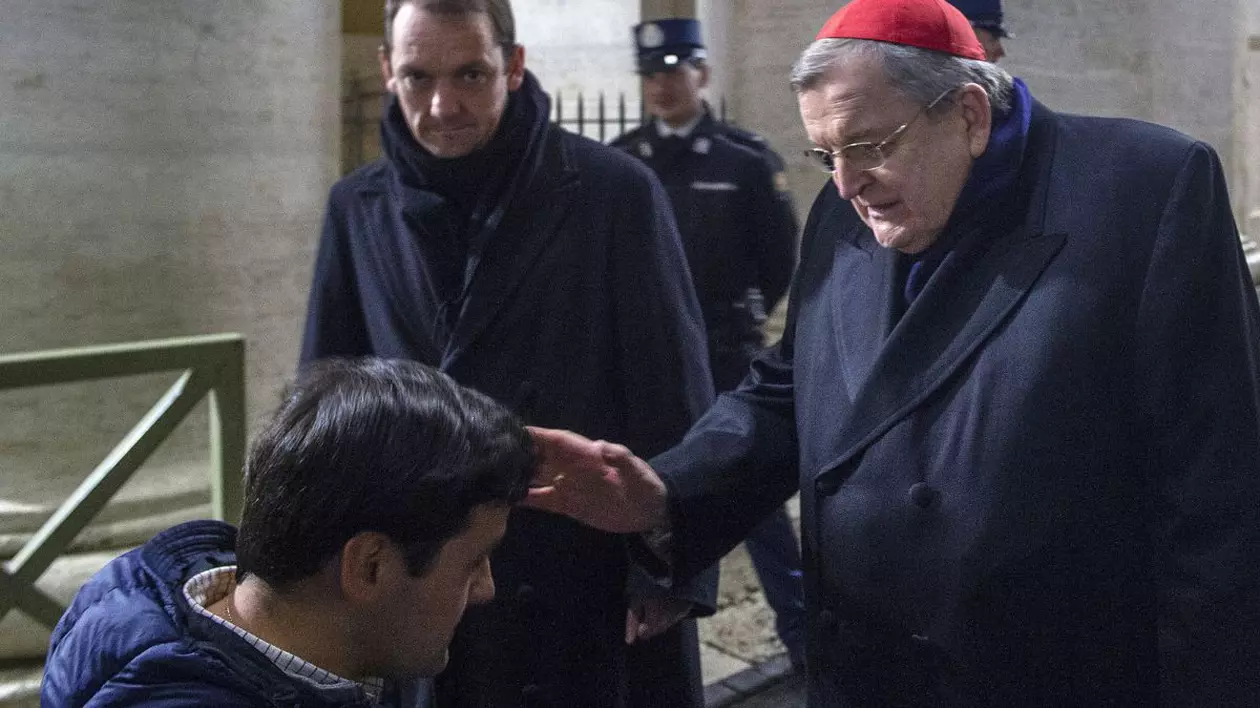 Cardinalul american conservator Raymond Burke binecuvântează un grup de băieți francezi după o rugăciune de rozariu nocturnă pentru sănătatea Papei Francisc în Piața Sfântul Petru din Vatican. Vatican, 26 februarie 2025.