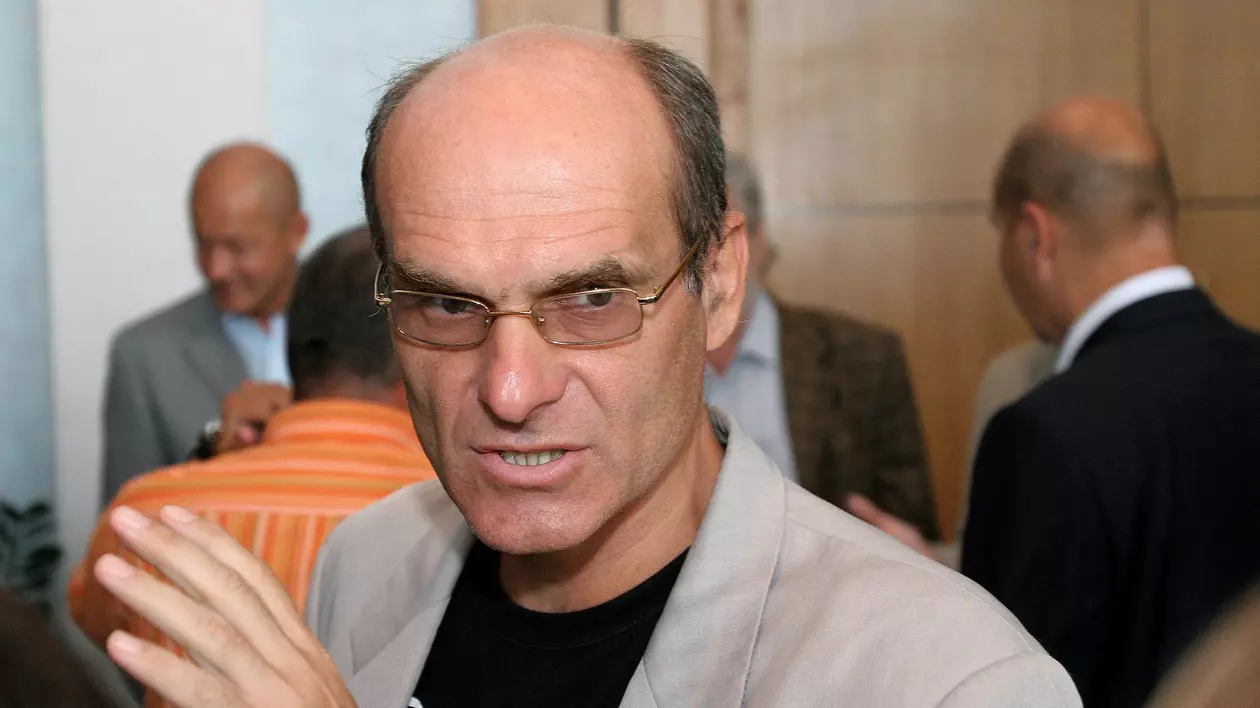 Poză cu Cristian Tudor Popescu în timp ce ține o mână ridicată