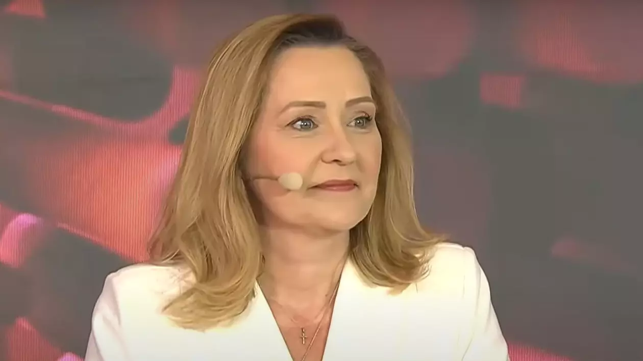 Elena Lasconi zâmbește la dezbaterea electorală, unde are rochie albă și bijuterii aurii