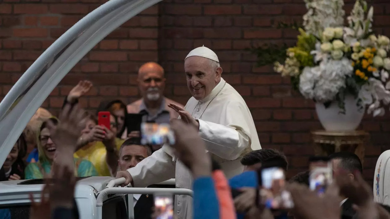 Papa Francisc slută oamenii, zâmbind, laa vizit în România, în 2019.