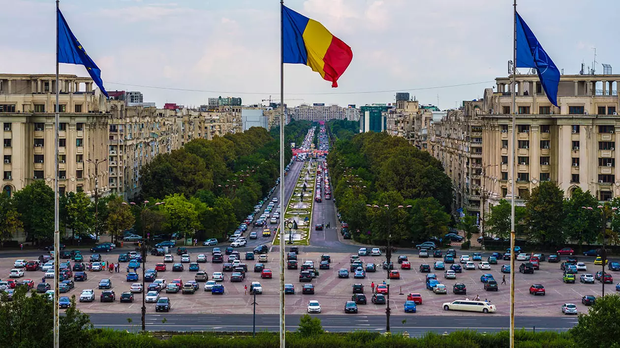 Steagurile României, Uniunii Europene și NATO pe fundalul Bulevardul Unirii