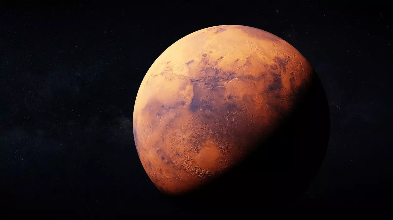 randare realistica a planetei Marte. jumătatea de sus a planetei are o culoare roșie și este luminată iar jumătatea de jos apare întunecată. fundal imaginii este negru