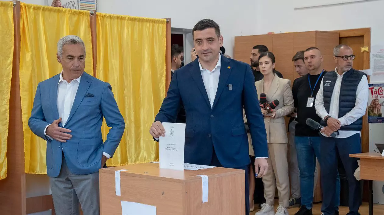 George Simion introduce buletinul de vot în urnă, lângă el este Călin Georgescu
